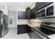 Well-appointed kitchen featuring stainless steel appliances, granite countertops, and ample cabinet space at 15738 Applewhite Cir, Port Charlotte, FL 33981