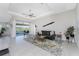 Bright and airy living room with modern decor and sliding glass doors to the outdoor patio at 15738 Applewhite Cir, Port Charlotte, FL 33981