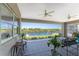 Covered patio with ceiling fans overlooks a serene waterfront view and private dock at 15738 Applewhite Cir, Port Charlotte, FL 33981