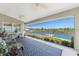 Covered patio with comfortable seating and a scenic waterfront view, perfect for outdoor relaxation at 15738 Applewhite Cir, Port Charlotte, FL 33981