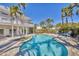 Lush backyard pool featuring rock waterfall, stone pavers, and adjacent deck with outdoor seating at 16251 Sunset Pines Cir, Boca Grande, FL 33921