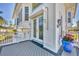 Elegant entrance features an etched glass door, lovely potted plant and a stylish gray porch at 16251 Sunset Pines Cir, Boca Grande, FL 33921