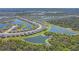 Expansive aerial view of a residential community with waterfront homes and lush landscaping at 1758 Saddlewood Cir, Port Charlotte, FL 33953