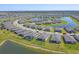 Stunning aerial view showcases the community's single-Gathering homes along a beautiful lake at 1758 Saddlewood Cir, Port Charlotte, FL 33953