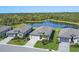 Aerial view of homes with meticulously maintained lawns surrounding a serene pond and wooded preserve at 1758 Saddlewood Cir, Port Charlotte, FL 33953