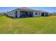 Spacious backyard with a screened patio, perfect for outdoor relaxation and entertaining with a view of the green landscape at 1758 Saddlewood Cir, Port Charlotte, FL 33953