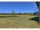 Expansive backyard featuring lush green grass, a tranquil lake view, and a peaceful setting, perfect for outdoor enjoyment at 1758 Saddlewood Cir, Port Charlotte, FL 33953