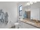 Well-lit bathroom with granite countertops, a shower with tile surround, and modern fixtures at 1758 Saddlewood Cir, Port Charlotte, FL 33953