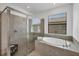 Modern bathroom with a glass-enclosed shower and a large soaking tub beneath a window with privacy blinds at 1758 Saddlewood Cir, Port Charlotte, FL 33953