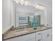 Elegant bathroom with double vanity, granite countertop, and a luxurious soaking tub at 1758 Saddlewood Cir, Port Charlotte, FL 33953