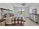 Comfortable bedroom features a ceiling fan and a view to the lake at 1758 Saddlewood Cir, Port Charlotte, FL 33953