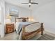 Inviting bedroom boasts wooden accents, a nightstand, area rug, and a ceiling fan at 1758 Saddlewood Cir, Port Charlotte, FL 33953