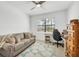 Comfortable bedroom with a plush sofa, desk, and a ceiling fan for optimal comfort at 1758 Saddlewood Cir, Port Charlotte, FL 33953