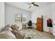 Comfortable bedroom with a plush sofa, desk, and a ceiling fan for optimal comfort at 1758 Saddlewood Cir, Port Charlotte, FL 33953