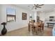 Bright dining room with a ceiling fan, view to the back yard and table with seating for four at 1758 Saddlewood Cir, Port Charlotte, FL 33953