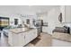 Open kitchen with island and granite countertops, flowing into a dining and living area overlooking the lake at 1758 Saddlewood Cir, Port Charlotte, FL 33953