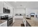 Spacious kitchen with stainless steel appliances and granite countertops, perfect for cooking and entertaining at 1758 Saddlewood Cir, Port Charlotte, FL 33953