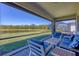 Screened lanai overlooking a serene pond and lush greenery, perfect for outdoor relaxation at 1758 Saddlewood Cir, Port Charlotte, FL 33953