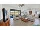 Inviting living space with neutral couches, large windows, and a view of the tranquil pond at 1758 Saddlewood Cir, Port Charlotte, FL 33953