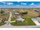 Aerial view of a house and community that features a golf course, single Gathering homes, and waterways at 2 Bunker Way, Rotonda West, FL 33947