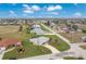 Aerial view of golf course community featuring single-Gathering homes with well-maintained lawns and mature trees at 2 Bunker Way, Rotonda West, FL 33947