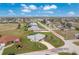 An aerial view of a single-story home circled in red, showcasing its backyard and landscaping at 2 Bunker Way, Rotonda West, FL 33947