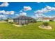 Well-maintained backyard with green grass, landscaping, and a screened in pool at 2 Bunker Way, Rotonda West, FL 33947