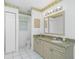 Bright bathroom with tiled floor, granite vanity, and well-lit mirror at 2 Bunker Way, Rotonda West, FL 33947