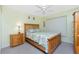 Bright bedroom with a wooden frame bed, side table, and soft, natural light from the window at 2 Bunker Way, Rotonda West, FL 33947