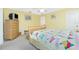 Comfortable bedroom with neutral carpet, ceiling fan, colorful quilt on bed, and adjacent shelving at 2 Bunker Way, Rotonda West, FL 33947