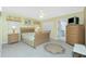 Cozy bedroom features soft carpet, ceiling fan, queen bed with floral quilt, and ensuite bathroom at 2 Bunker Way, Rotonda West, FL 33947