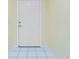 Clean entryway with white tiled floors and a crisp white door at 2 Bunker Way, Rotonda West, FL 33947