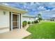 Close up on the front entrance of this home, showing the well kept lawn and fresh landscaping at 2 Bunker Way, Rotonda West, FL 33947