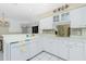 Bright kitchen featuring white cabinets, tile backsplash, and modern appliances at 2 Bunker Way, Rotonda West, FL 33947