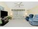 Comfortable living room featuring floral sofa and ceiling fan at 2 Bunker Way, Rotonda West, FL 33947