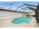 Private pool with screen enclosure and surrounding patio space at 2 Bunker Way, Rotonda West, FL 33947
