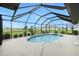 Screened pool with a handrail, surrounded by patio and landscaping at 2 Bunker Way, Rotonda West, FL 33947