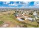 Aerial view of a home with a screened-in pool and a well-maintained lawn on a golf course community at 20 Bunker Way, Rotonda West, FL 33947