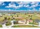 Aerial view of the property featuring a golf course and surrounding homes at 20 Bunker Way, Rotonda West, FL 33947