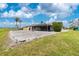 Exterior view showing screened pool, backyard, and lush landscaping at 20 Bunker Way, Rotonda West, FL 33947