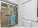 Bathroom featuring a glass door shower stall and a white toilet at 20 Bunker Way, Rotonda West, FL 33947