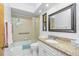 Bathroom featuring a shower-tub combo, granite vanity, and neutral color palette at 20 Bunker Way, Rotonda West, FL 33947