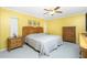 Bright bedroom with a ceiling fan, two bedside tables, and a dresser at 20 Bunker Way, Rotonda West, FL 33947