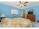 Bedroom with blue walls, ceiling fan, and carpeted floor at 20 Bunker Way, Rotonda West, FL 33947