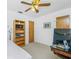 Bright bedroom with neutral carpet, ceiling fan, and built-in bookcase at 20 Bunker Way, Rotonda West, FL 33947