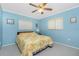 Bedroom with a blue walls, ceiling fan, and carpeted floor at 20 Bunker Way, Rotonda West, FL 33947