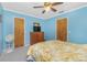 Bedroom with blue walls, ceiling fan, carpeted floor and wood dresser with TV at 20 Bunker Way, Rotonda West, FL 33947