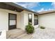 Inviting front entrance with a neutral color scheme, complemented by landscaping and well kept concrete at 20 Bunker Way, Rotonda West, FL 33947