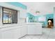 Open kitchen with white cabinetry, tile floors and views of the living room at 20 Bunker Way, Rotonda West, FL 33947