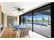Enclosed lanai boasts tiled floor, ceiling fan, and views of the pool and golf course at 20 Bunker Way, Rotonda West, FL 33947